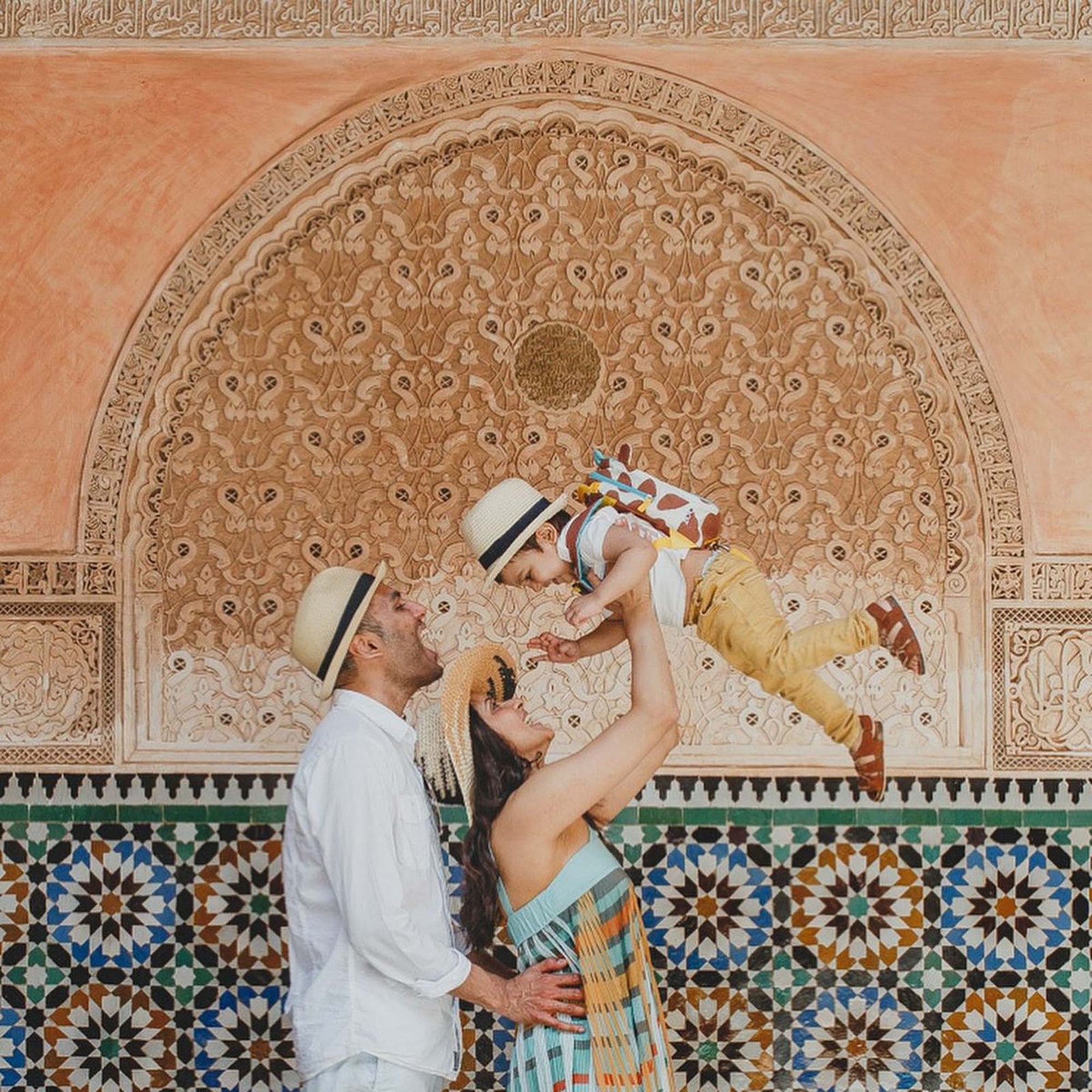 Family enjoying a moment together in front of Moroccan architecture